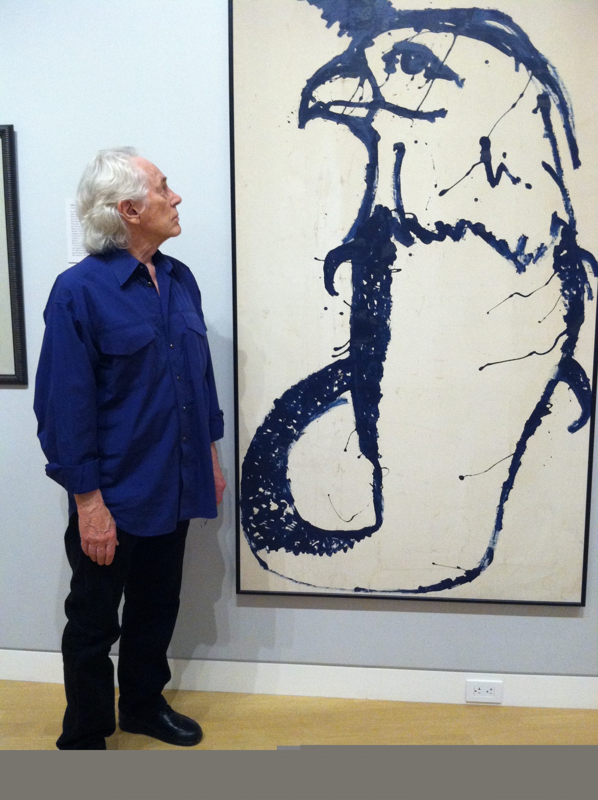 Michael McClure in front of one of his paintings at an exhibition in Sacramento by Amy Evans McClure